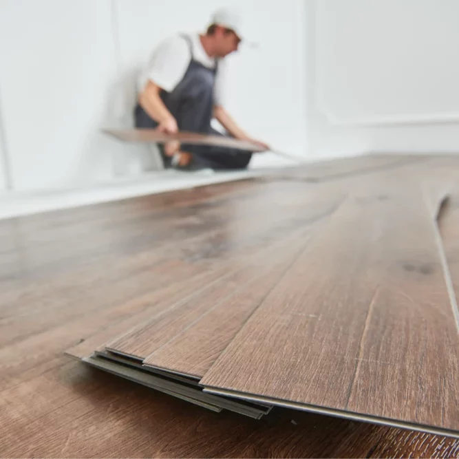 installingplanks Worker installing vinyl flooring | Best Buy Interior Finishes
